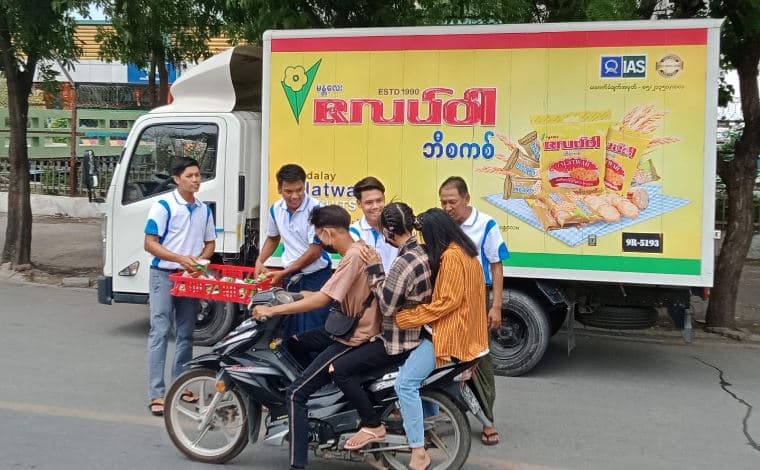 Win MATA distribution team beside a delivery vehicle